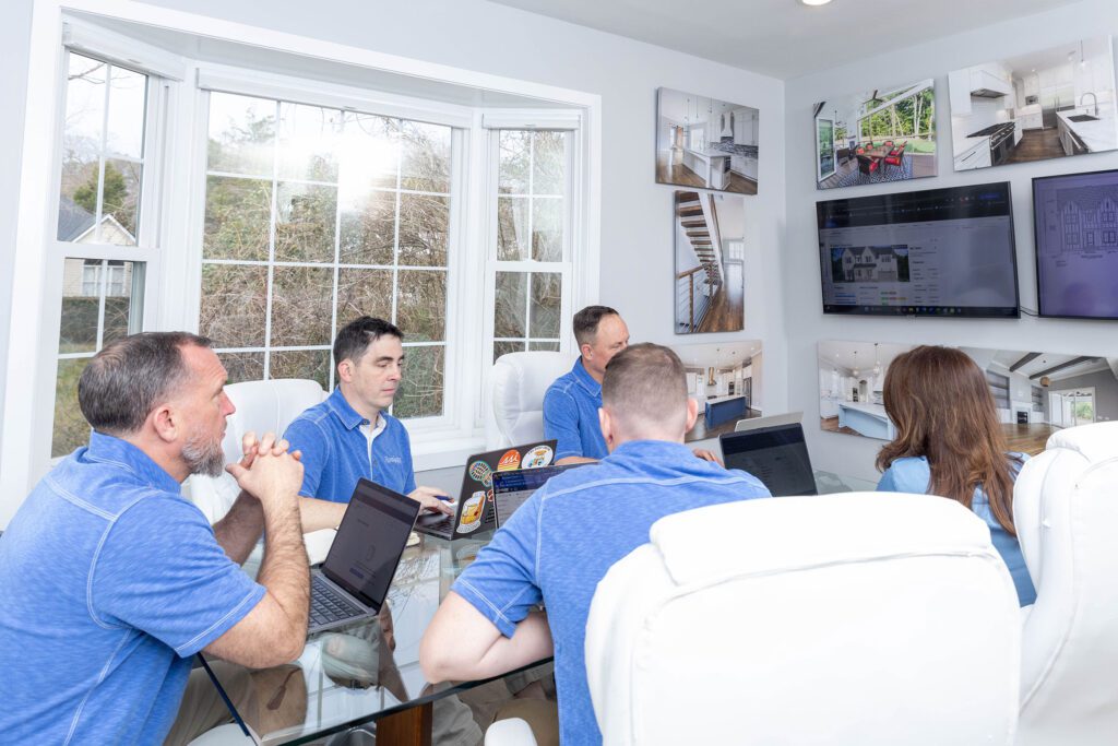 Revolution Homes Team Sitting and Talking at the Table