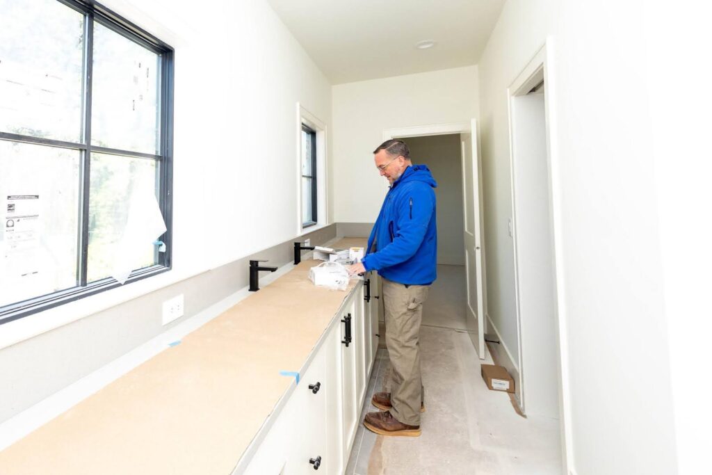Revolution Homes worker working on an unfinished kitchen 